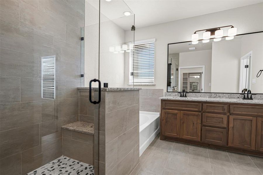 Bathroom with a garden tub, a shower stall, double vanity, and recessed lighting