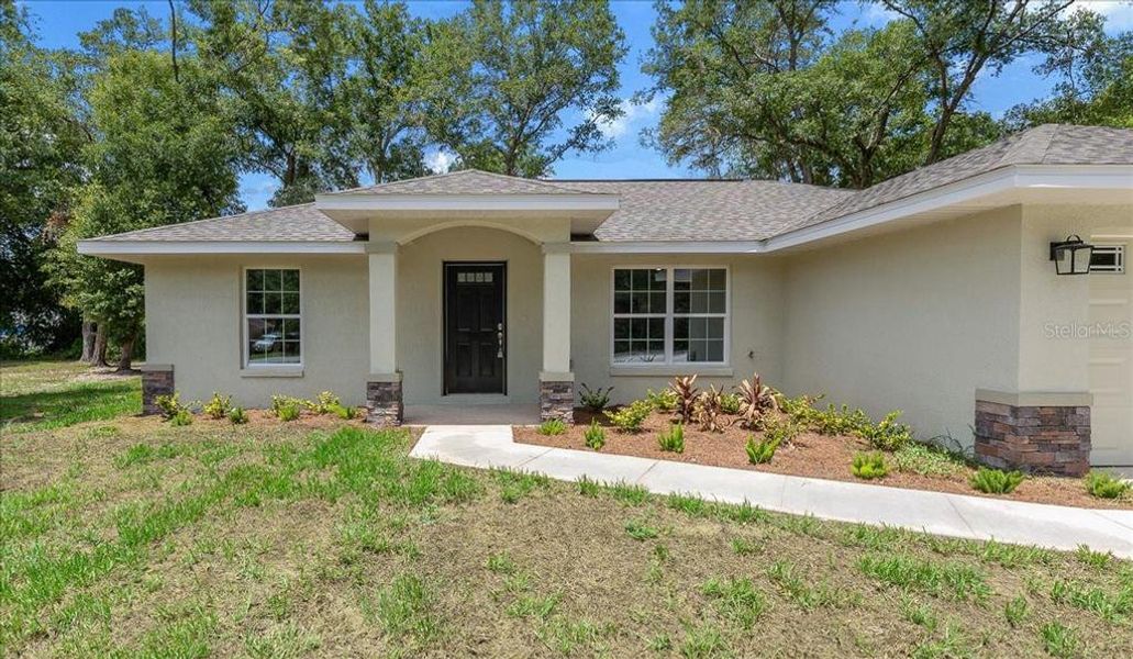 Front exterior of a new home in , Belleview, FL, highlighting curb appeal (Image 17).