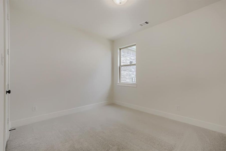 Neutral-toned room featuring a single window and recessed lighting