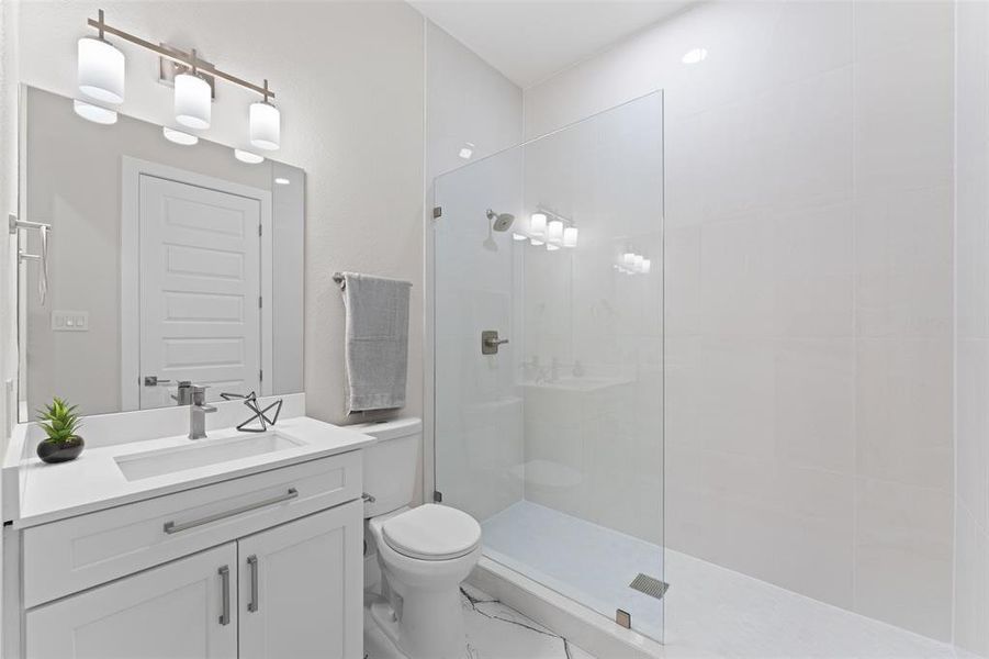 Bathroom with vanity, a walk in shower, and marble finish flooring Bathroom with vanity, a walk in shower, and marble finish flooring