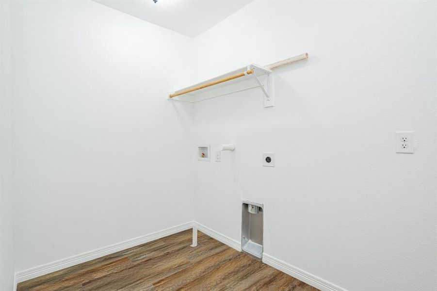 Clothes washing area with electric dryer hookup, hardwood / wood-style flooring, and hookup for a washing machine