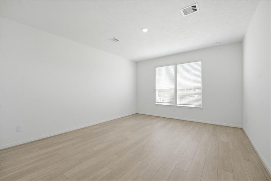 Come and unwind after a long day in this magnificent primary suite! This spacious room features vinyl plank flooring, neutral paint, high ceilings and large windows with privacy blinds.