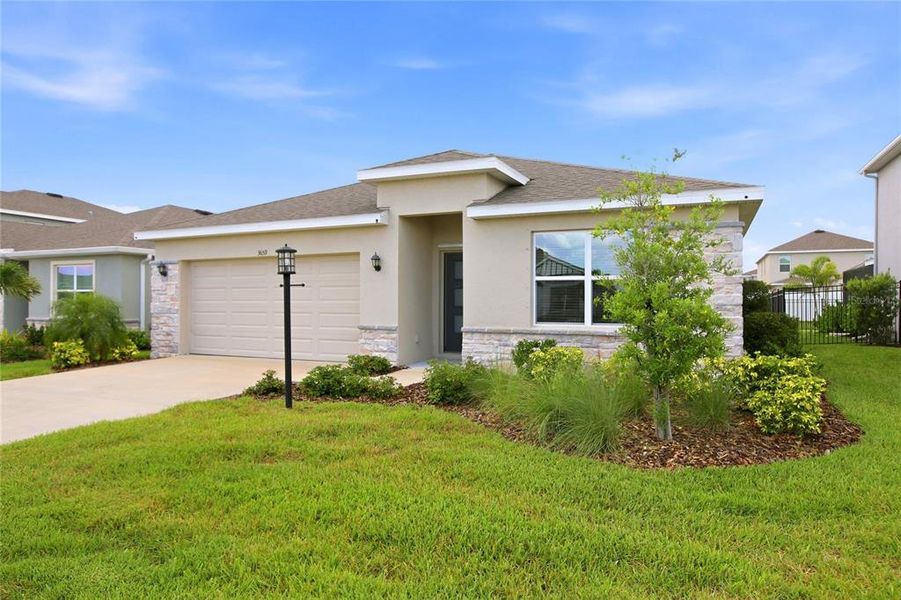 Front exterior of a new home in , Bradenton, FL, highlighting curb appeal (Image 29).