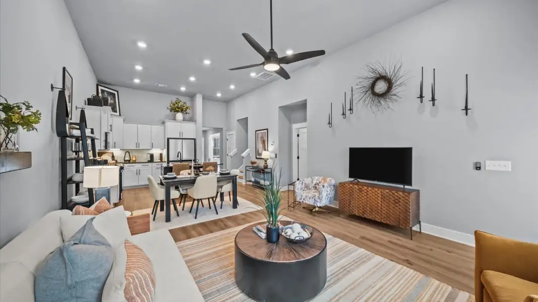 Eye-catching two-story family room with elegant trim, oversized windows, and elevated design Eye-catching two-story family room with elegant trim, oversized windows, and elevated design