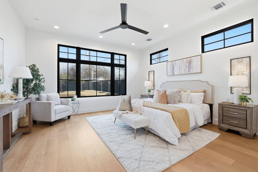 Bedroom featuring light wood-style floors, a ceiling fan, and recessed lighting