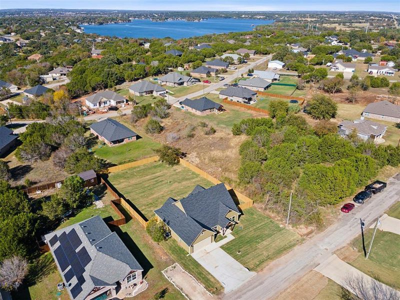 Birds eye view of property with a water view