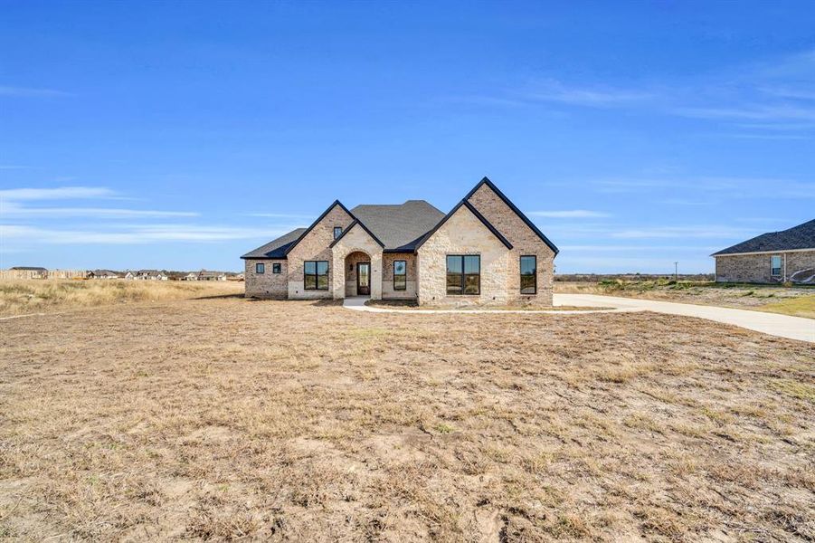 Front exterior of a new home in , Waxahachie, TX, highlighting curb appeal (Image 2). Front exterior of a new home in , Waxahachie, TX, highlighting curb appeal (Image 2).
