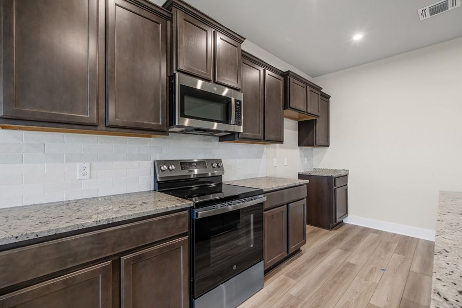 Representative furnished interior of a home built from the Newport by Omega Builders in Southern Pointe, College Station (Image 7).