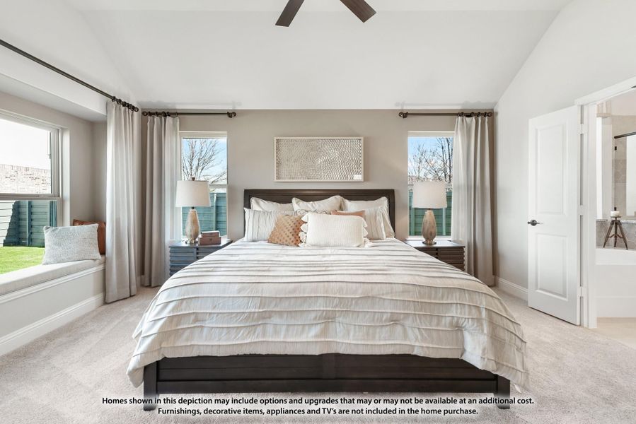 Master bedroom with vaulted ceiling, ceiling fan, carpet floors, window seat, and ensuite bathroom door visible.