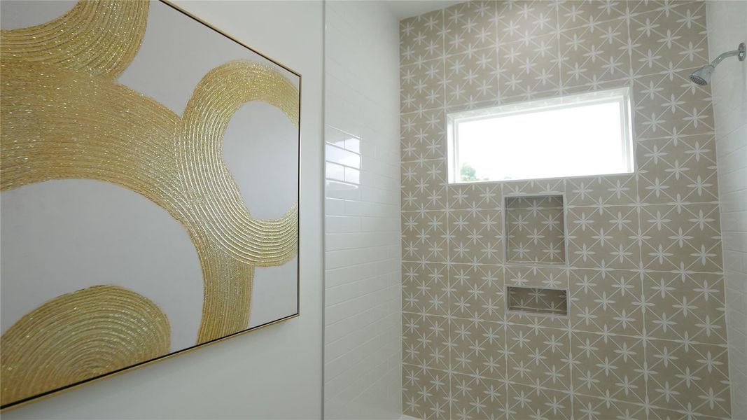 The bathroom features a modern design with star-patterned tiles and a window providing natural light. It includes built-in shelves and a stylish abstract artwork on the wall. The bathroom features a modern design with star-patterned tiles and a window providing natural light. It includes built-in shelves and a stylish abstract artwork on the wall.