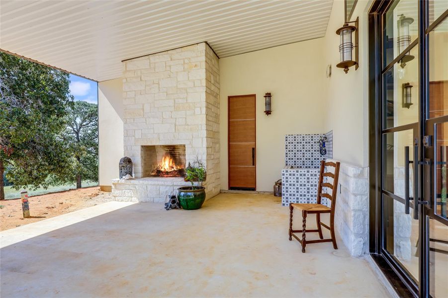 View of patio / terrace with an outdoor stone fireplace