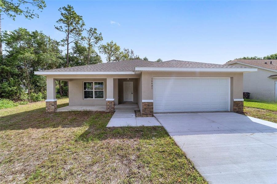 Front exterior of a new home in , Dunnellon, FL, highlighting curb appeal (Image 1).