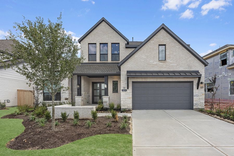 Front exterior of a new home in Bridgeland, Cypress, TX, highlighting curb appeal (Image 2). Front exterior of a new home in Bridgeland, Cypress, TX, highlighting curb appeal (Image 2).
