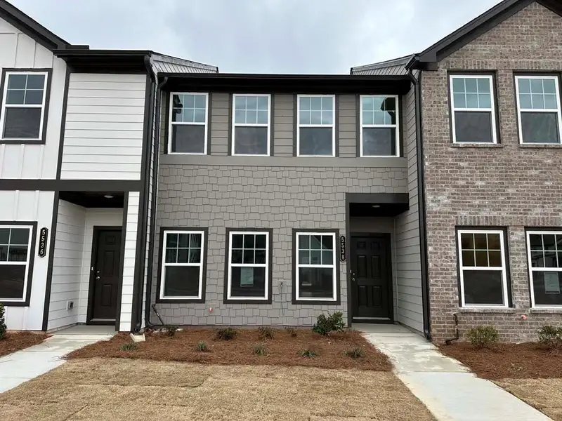 Front exterior of a new home in Laurelwood, Douglasville, GA, highlighting curb appeal (Image 1). Front exterior of a new home in Laurelwood, Douglasville, GA, highlighting curb appeal (Image 1).