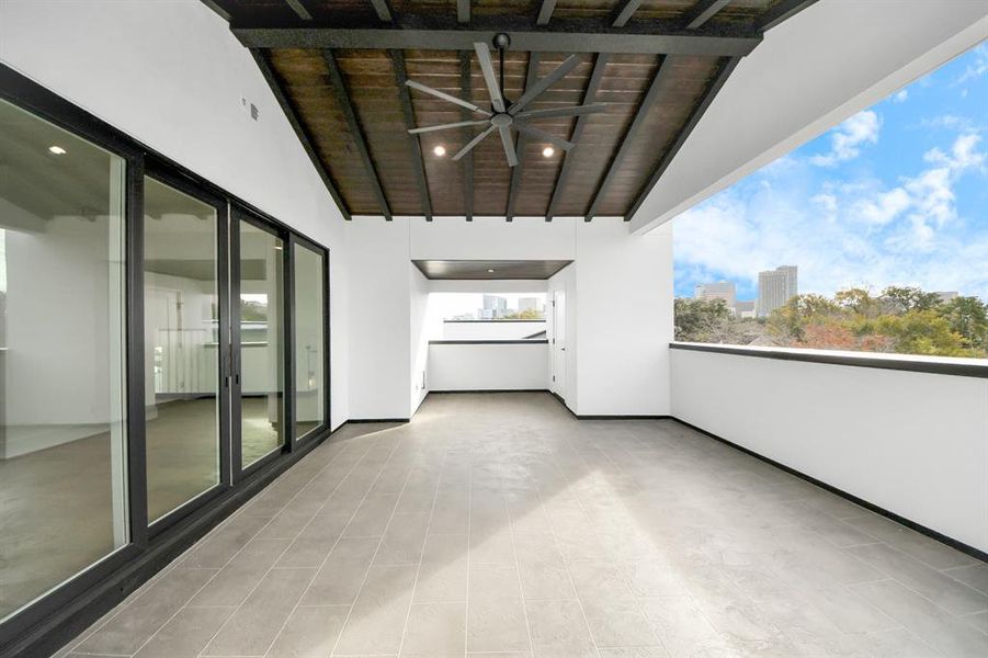 Another view of the covered 3rd-floor terrace, featuring durable tile flooring and open-air ambiance. A stylish retreat ideal for relaxing or hosting with breathtaking views.