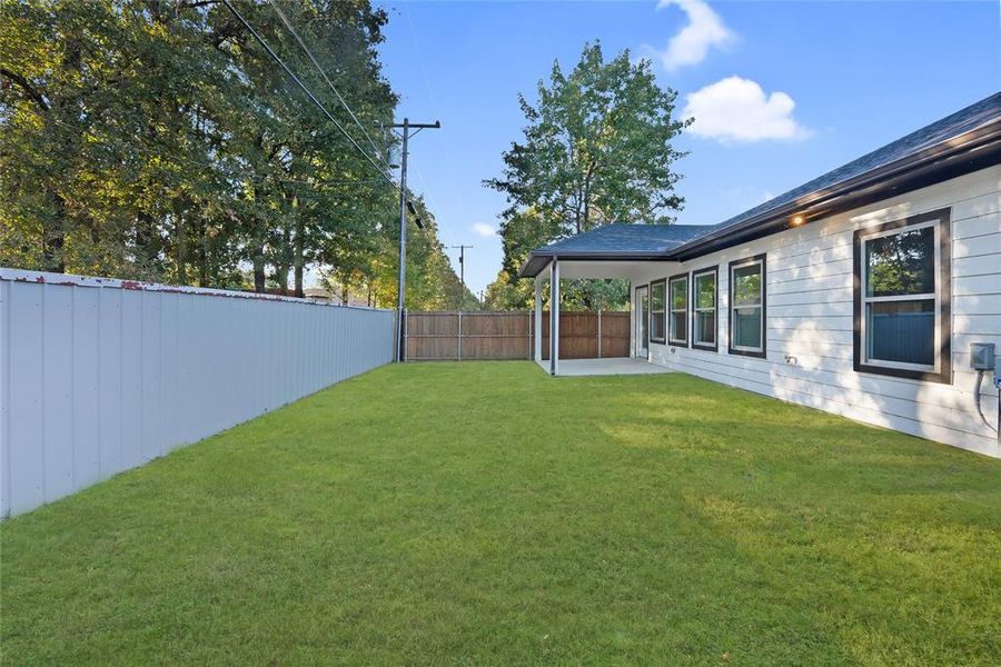 Fenced backyard featuring a patio area