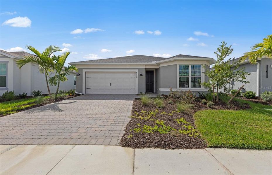 Front exterior of a new home in Reagan Landing, Bradenton, FL, highlighting curb appeal (Image 1). Front exterior of a new home in Reagan Landing, Bradenton, FL, highlighting curb appeal (Image 1).