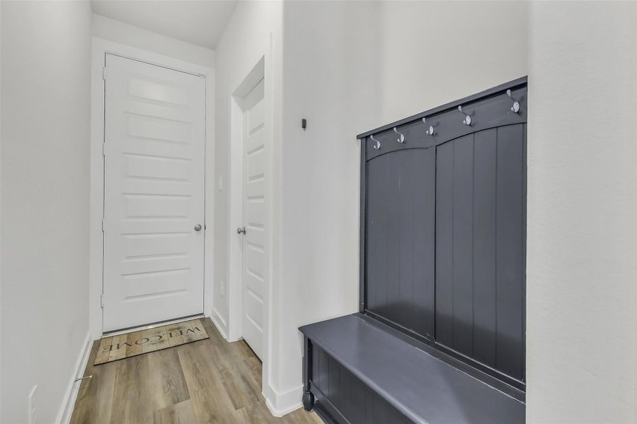 Functional mudroom/drop zone with built-in organization space, offering convenience and extra storage for busy households.