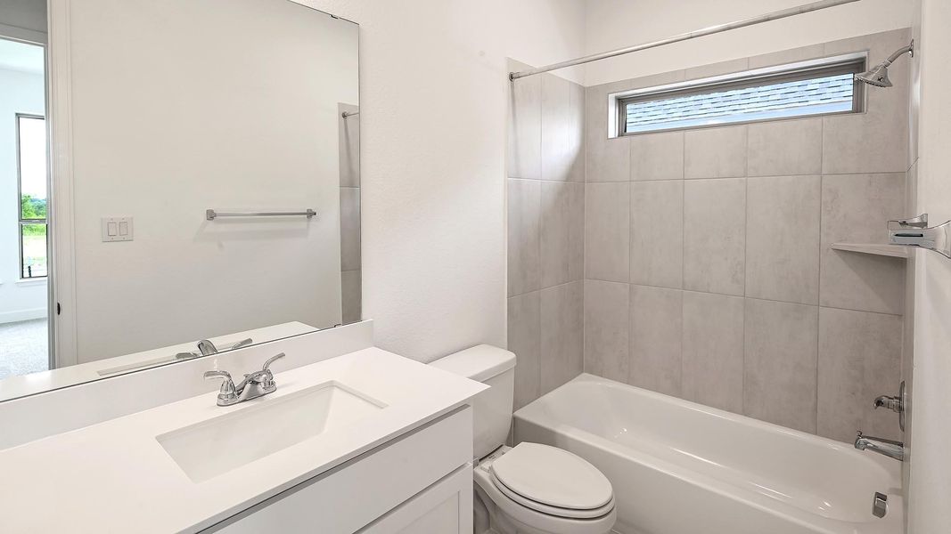 Bathroom featuring bathing tub / shower combination and vanity Bathroom featuring bathing tub / shower combination and vanity