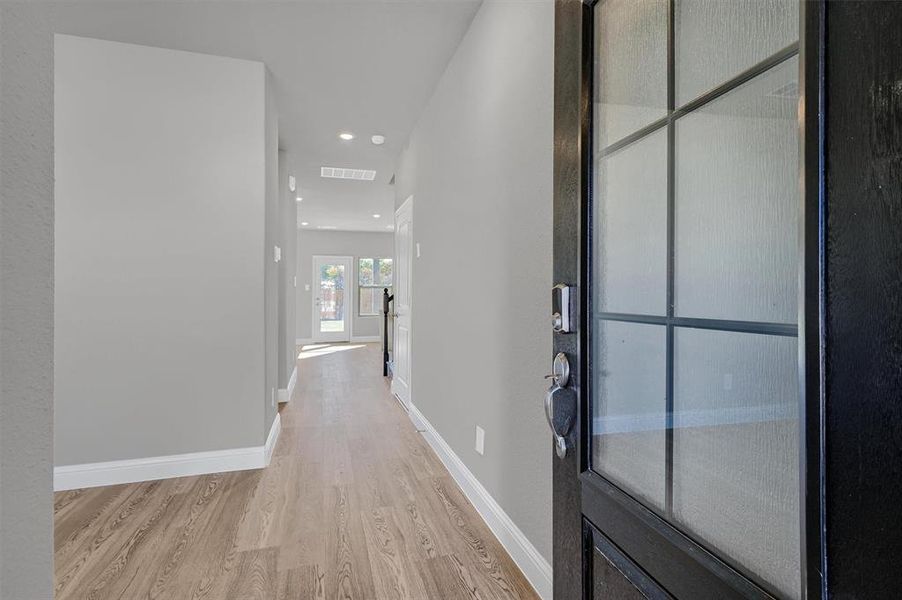 Corridor featuring light wood-type flooring