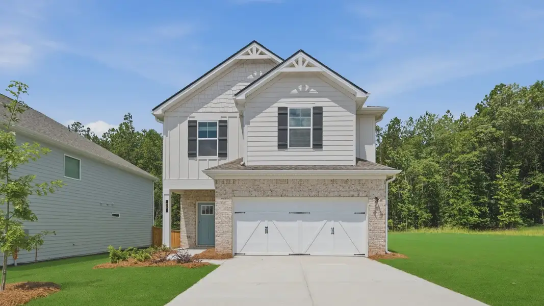 Front exterior of a new home in Enclave at Evergreen, Fairburn, GA, highlighting curb appeal (Image 1). Front exterior of a new home in Enclave at Evergreen, Fairburn, GA, highlighting curb appeal (Image 1).