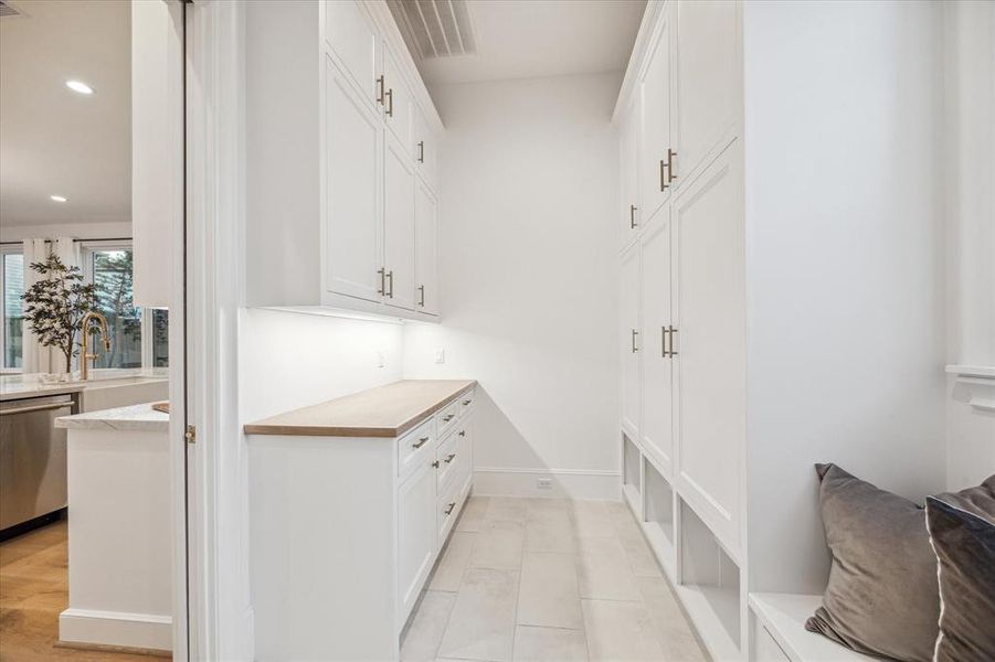 Your mudroom will stay beautifully tamed and organized w/ plenty of built-in storage, conveniently located off garage and kitchen for effortless access