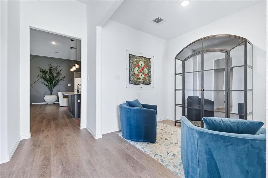 Living area featuring wood finished floors and recessed lighting