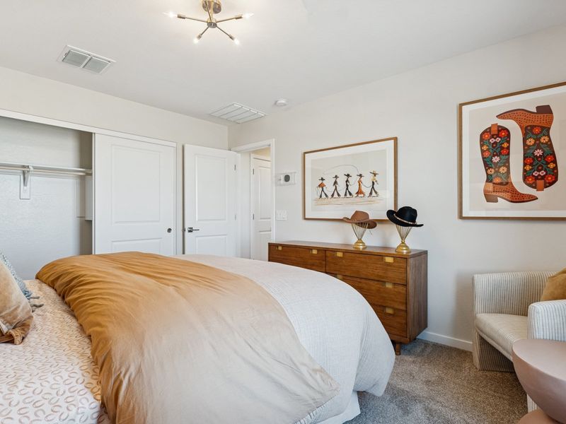 A bedroom with a bed and a table. A bedroom with a bed and a table.