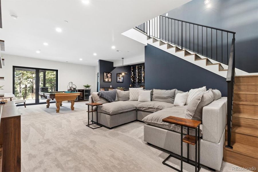 Lower-level walkout basement features a cozy family room, pool table, built in shelving and more Lower-level walkout basement features a cozy family room, pool table, built in shelving and more