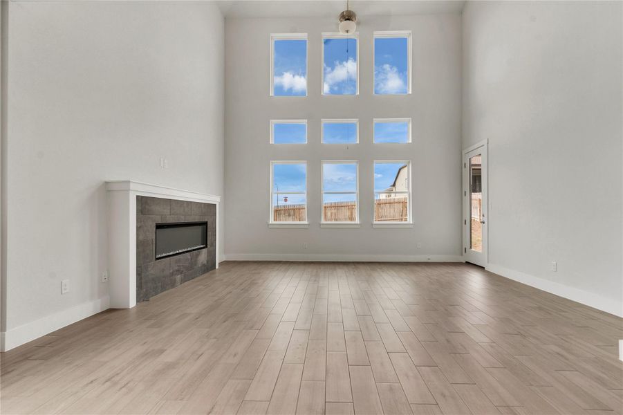 A striking modern fireplace and abundant natural light define this inviting living space.