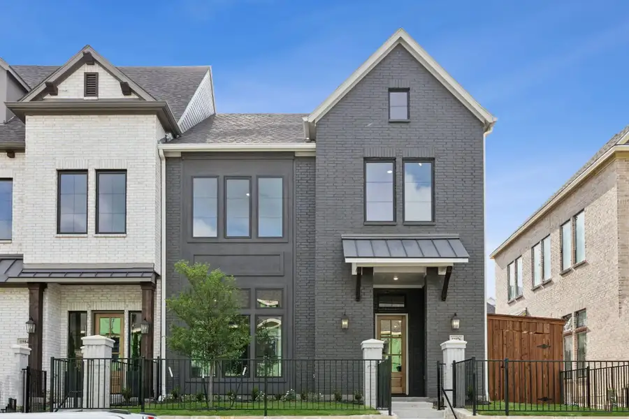 Front exterior of a new home in Newman Village Townhomes, Frisco, TX, highlighting curb appeal (Image 1). Front exterior of a new home in Newman Village Townhomes, Frisco, TX, highlighting curb appeal (Image 1).