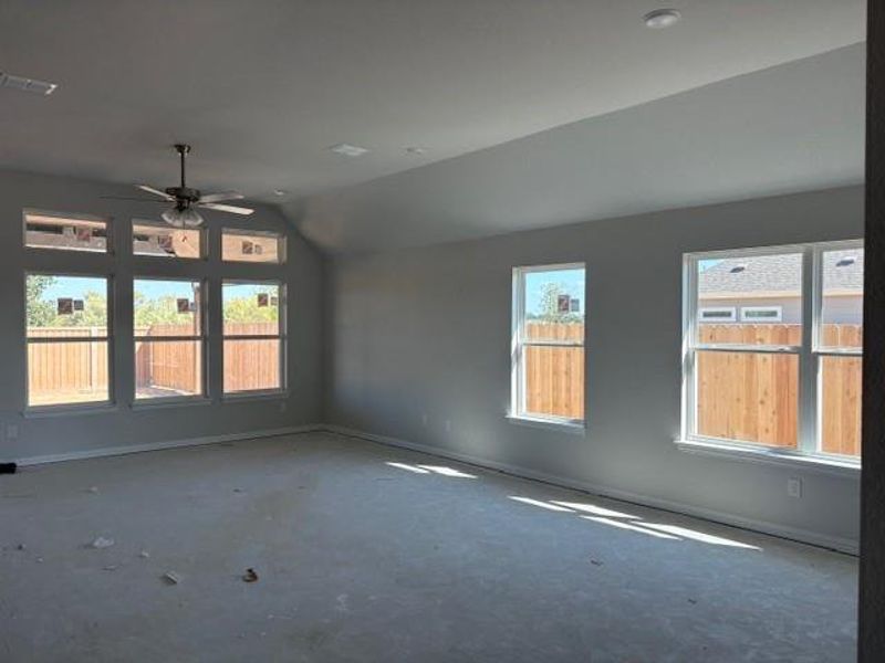 Unfurnished room with lofted ceiling and a ceiling fan Unfurnished room with lofted ceiling and a ceiling fan