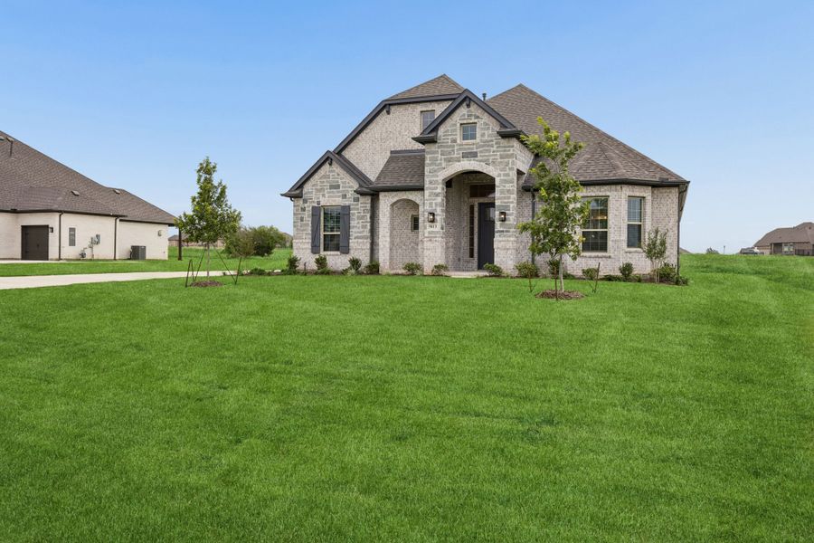 Front exterior of a new home in Joshua Meadows, Joshua, TX, highlighting curb appeal (Image 20).