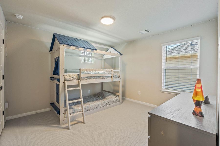 This cozy secondary bedroom features neutral walls, upgraded carpeting, upgraded hinges and door knobs in elegant black. This cozy secondary bedroom features neutral walls, upgraded carpeting, upgraded hinges and door knobs in elegant black.