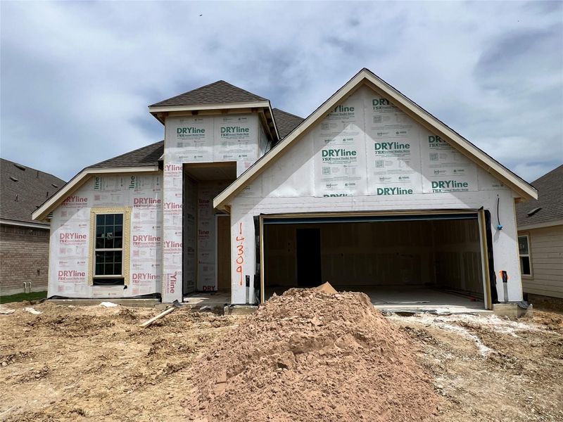 Unfinished property featuring roof with shingles and an attached garage
