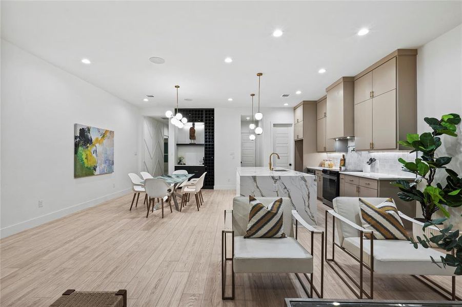 Kitchen with tasteful backsplash, gray cabinets, black electric range oven, and hanging light fixtures