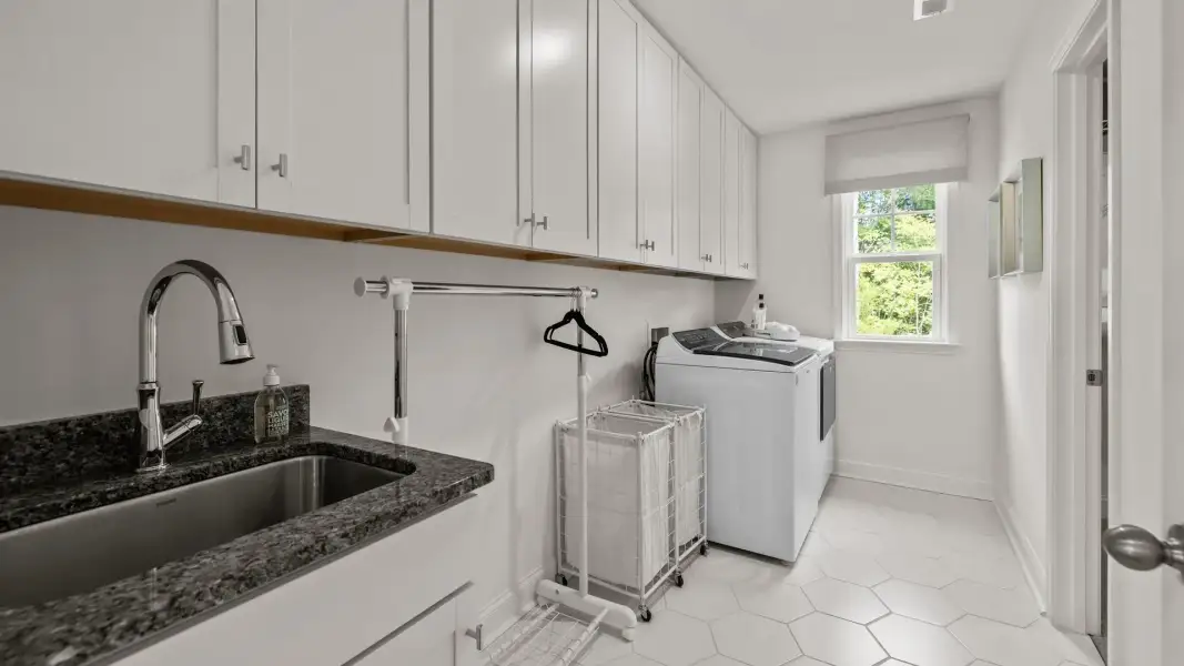 Ample laundry room with sink and plentiful cabinetry, in the Townsend Design by DRB Homes at Lakeside Glen in York, SC Ample laundry room with sink and plentiful cabinetry, in the Townsend Design by DRB Homes at Lakeside Glen in York, SC