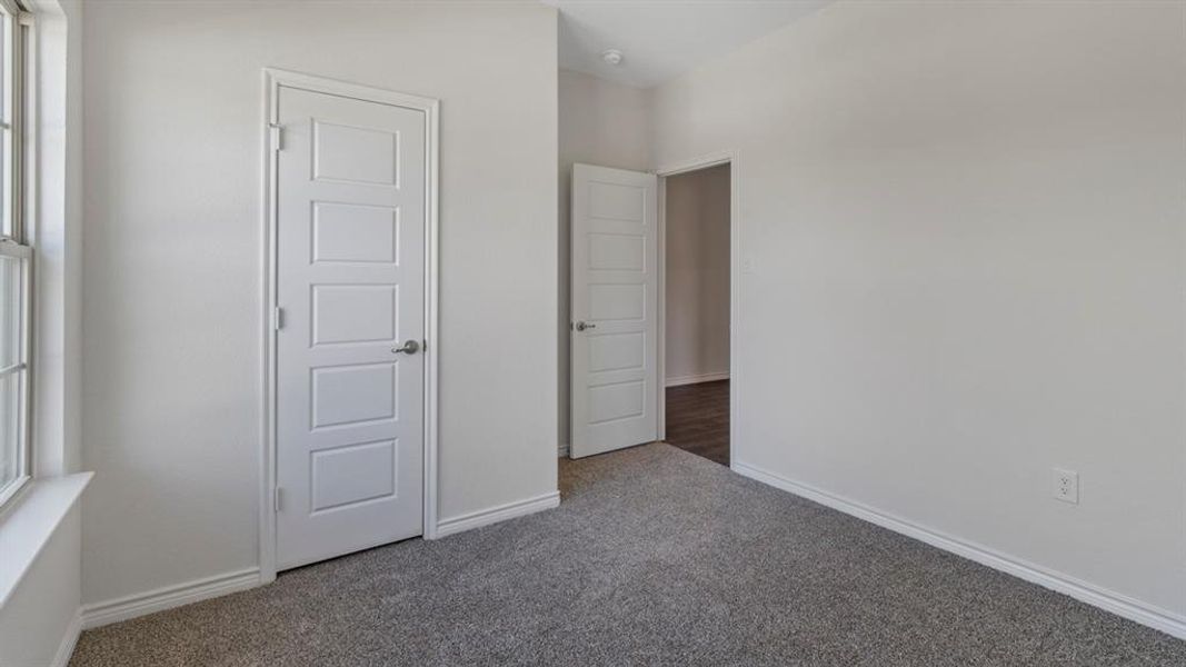 Unfurnished bedroom with baseboards and carpet Unfurnished bedroom with baseboards and carpet
