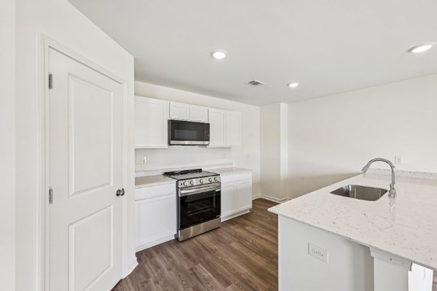A kitchen with white cabinets. A kitchen with white cabinets.