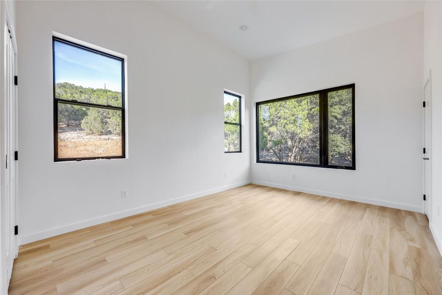 Unfurnished room featuring light wood-style flooring and baseboards Unfurnished room featuring light wood-style flooring and baseboards