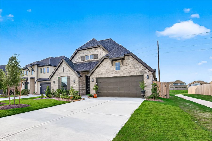 Front exterior of a new home in StoneCreek Estates, Richmond, TX, highlighting curb appeal (Image 26). Front exterior of a new home in StoneCreek Estates, Richmond, TX, highlighting curb appeal (Image 26).