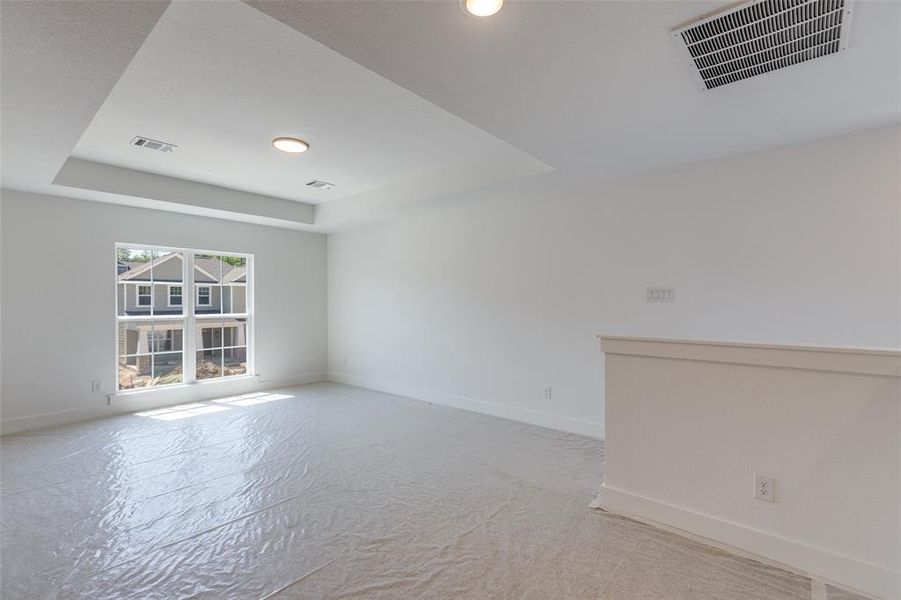 Spare room featuring a tray ceiling