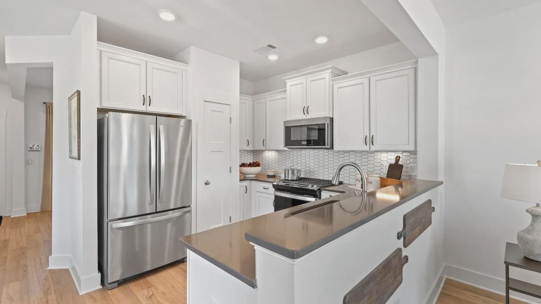 Well-designed kitchen of The Churchill Design with a center island and tasteful finishes that elevate everyday living