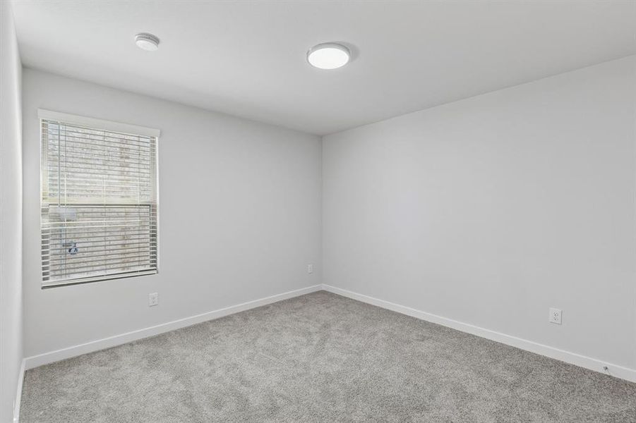 Bedroom in the Harrison home plan by Trophy Signature Homes – REPRESENTATIVE PHOTO