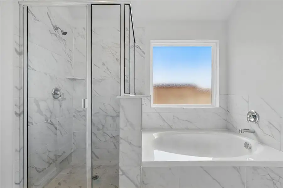 Full bath with a garden tub and a marble finish shower