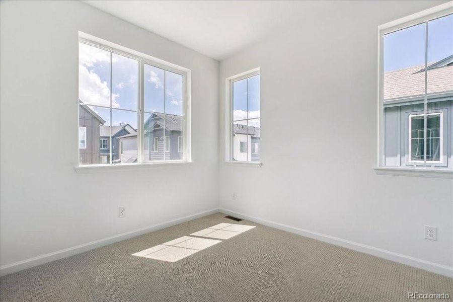 Spacious, unfurnished interior of a new home in Pacific Collection at The Townes at Skyline Ridge, Castle Pines (Image 16).