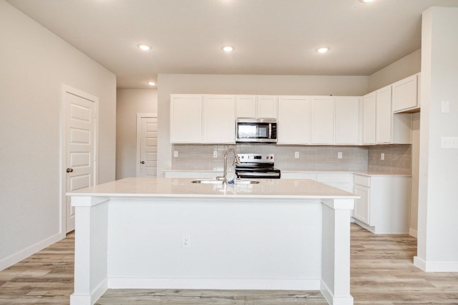 A kitchen with white cabinets. A kitchen with white cabinets.