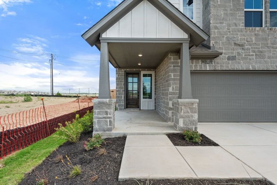 Exterior details and patio area of a home in Terrace Collection At Turner's Crossing, Buda (Image 3).
