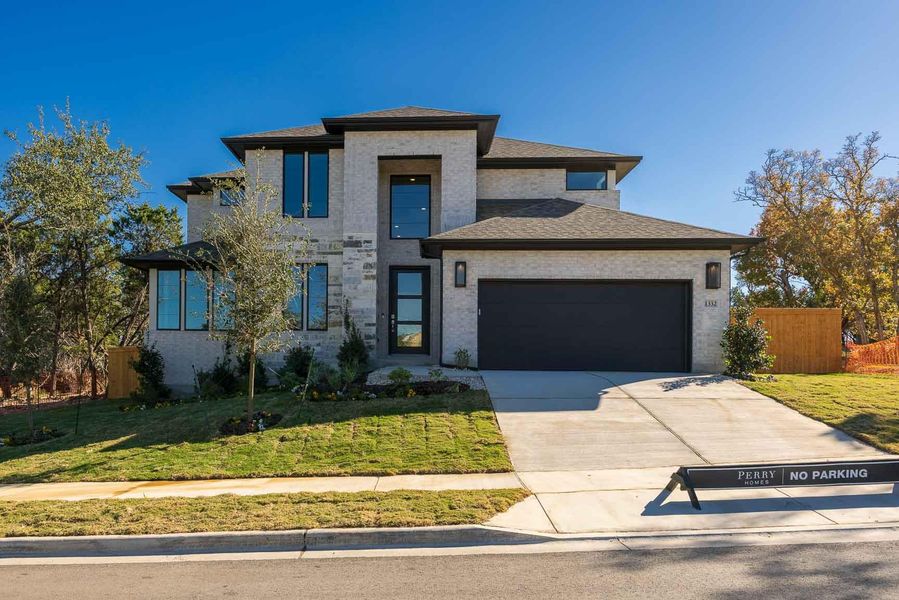 Front exterior of a new home in Parkside on the River, Georgetown, TX, highlighting curb appeal (Image 2).