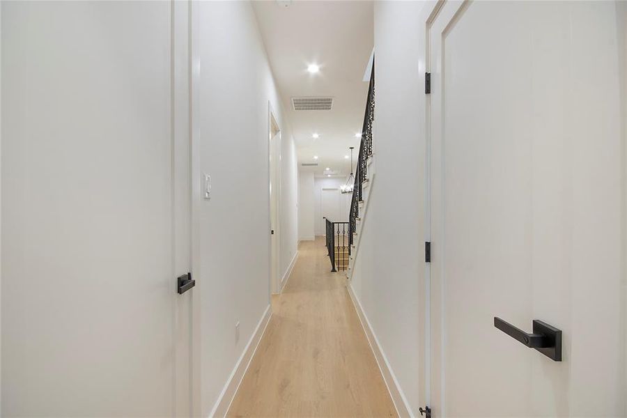 Corridor featuring light wood-type flooring and recessed lighting